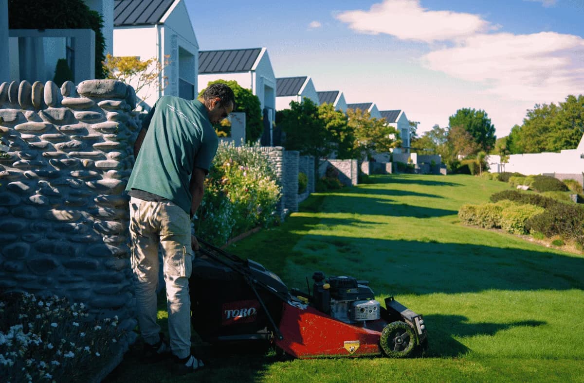 A Horizon team member mowing a lawn